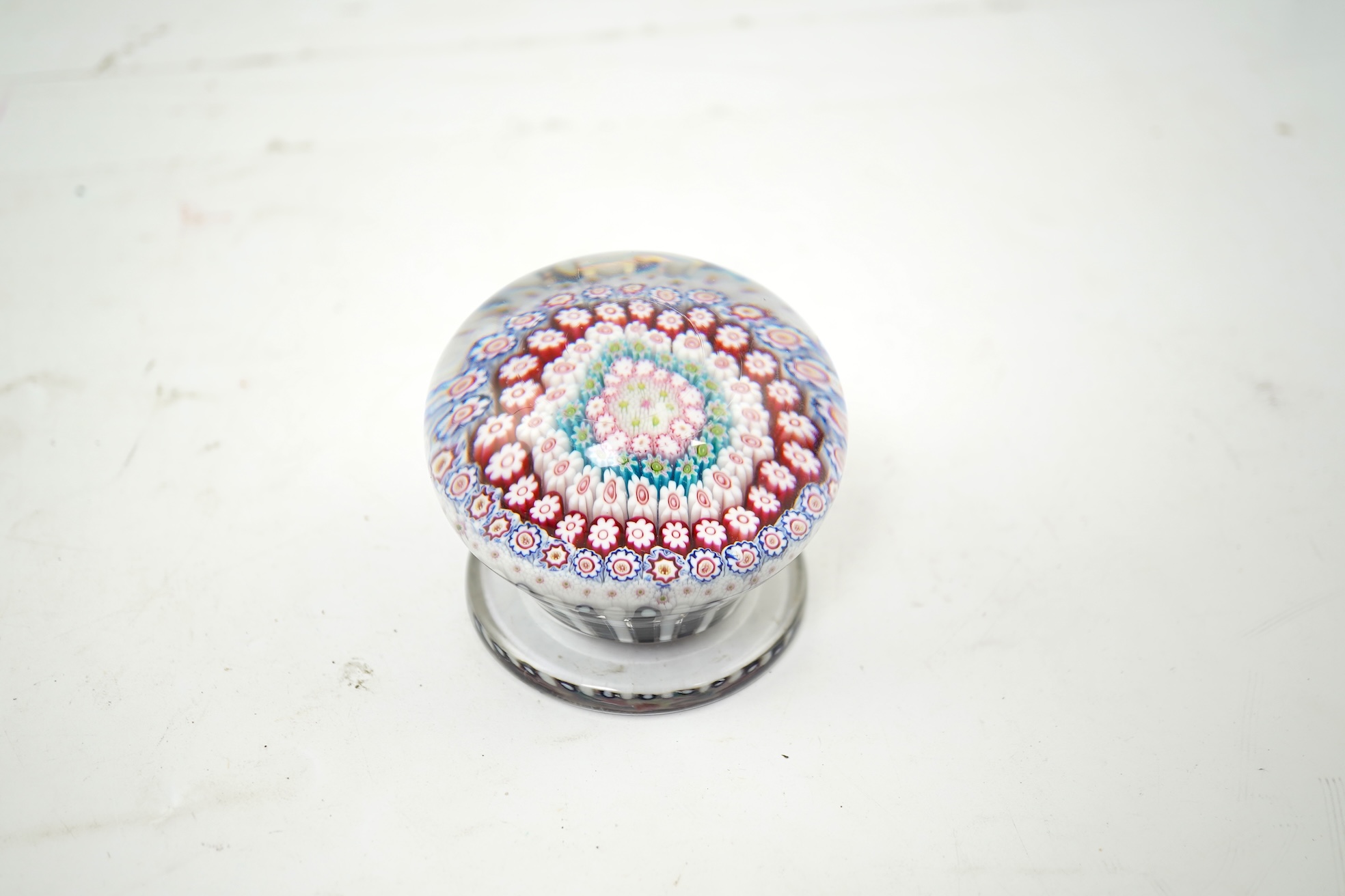A Clichy piedouche concentric millefiori paperweight, mid 19th century